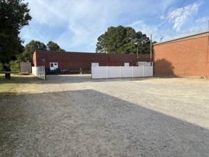 New fence with custom gates, in the rear of the building