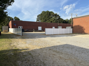 New fence with custom gates, in the rear of the building