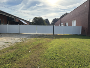 New fence with custom gates, in the rear of the building