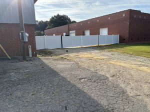New fence with custom gates, in the rear of the building