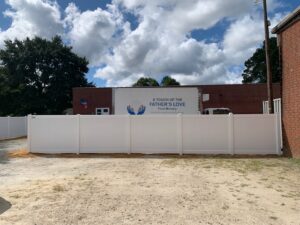 New fence with custom gates, in the rear of the building